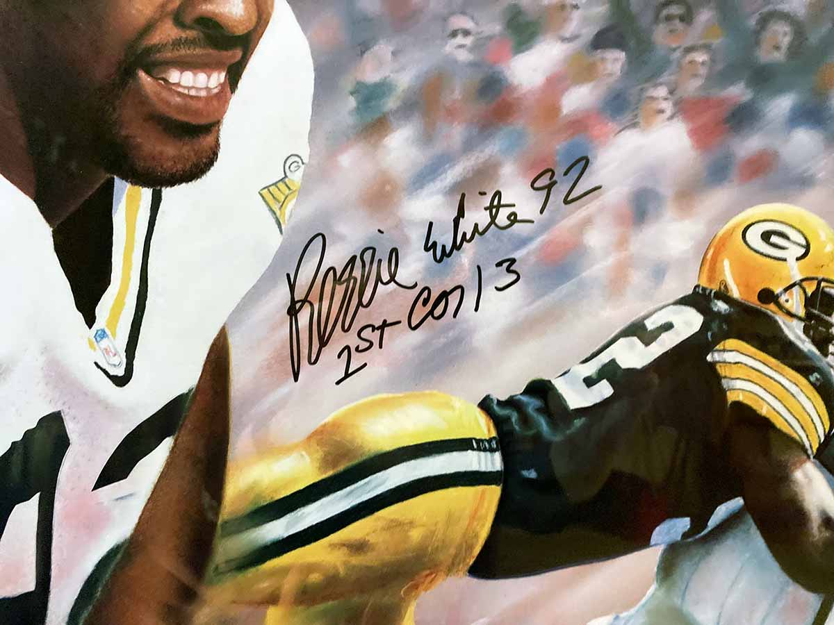 Leading By Example, personally signed by The Minister of Defense, Reggie White of the Green Bay Packers. The distinctive "1st Cor. 13" is inscribed below his signature. Double signed by the artist, Andrew Goralski.