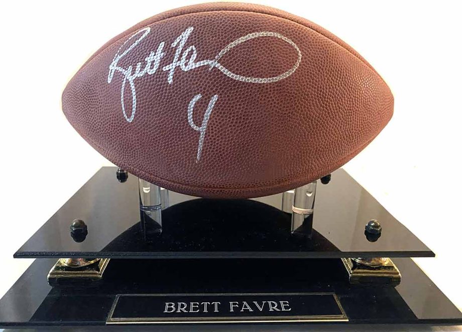 Regulation Wilson football signed by Green Bay Packer quarterback Brett Favre during the 1996-97 season. Includes plexiglass display case and Certificate of Authenticity. Available now from Art Agents International where creative collectibles are bought, sold, resold, brokered, and listed in a secure and private manner globally