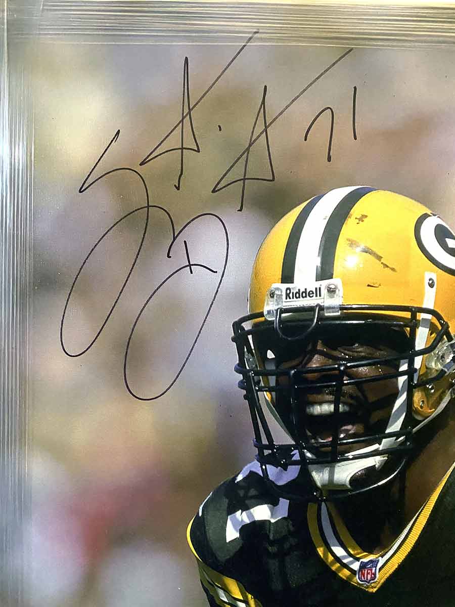 Santana Dotson is a former NFL defensive tackle. He played in two Super Bowls with the Green Bay Packers, one of which brought him a NFL Championship ring. Dotson autographed both the picture and Green Bay Packers helmet, both of which are a wonderful addition to any sports collection. Available now from Art Agents International where creative collectibles are bought, sold, resold, brokered, and listed in a secure and private manner globally